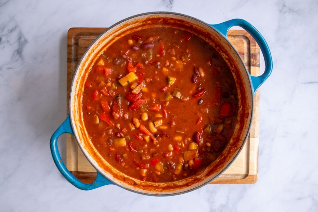 A blue soup pot with ingredients for five-bean after simmering.