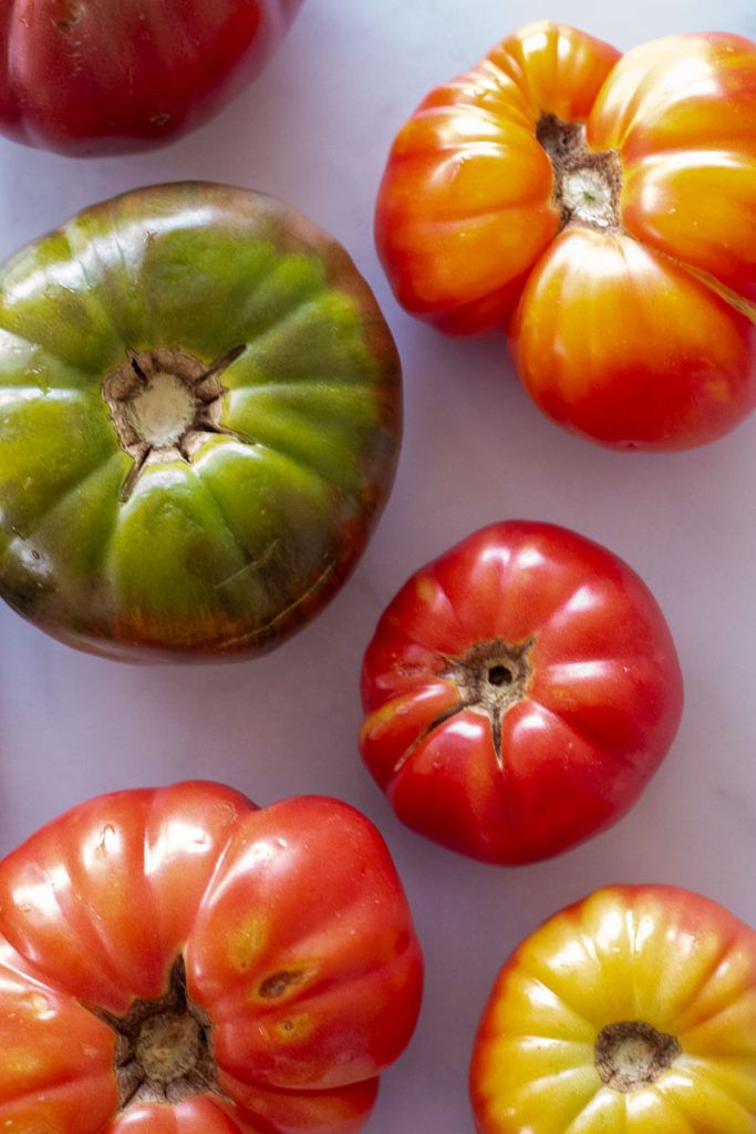 A variety of heirloom tomatoes shot from overhead.